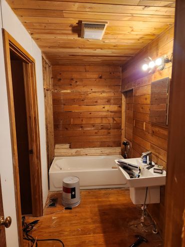 Renovated bathroom with fresh paint, upgraded vanity, shower upgrade & updated lighting fixtures.