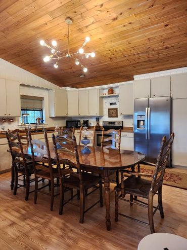 Kitchen renovation featuring sanded cabinets, new hinges, and updated hardware to save on costs.