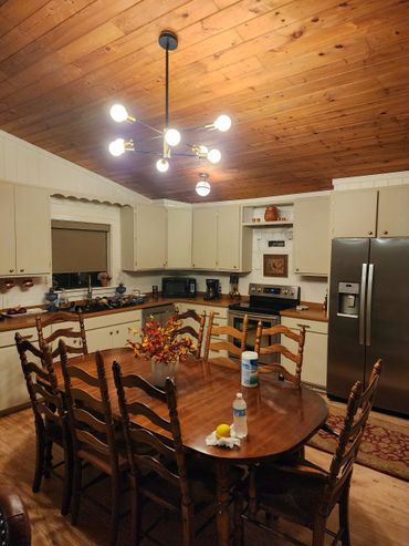 Kitchen renovation featuring sanded cabinets, new hinges, and updated hardware to save on costs.