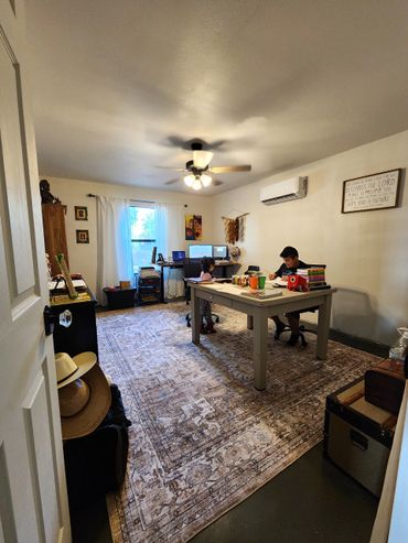 Spacious garage converted into a family entertainment room and functional office.