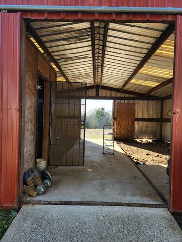 Barn cleanup in progress with debris removal and fresh coat of paint.