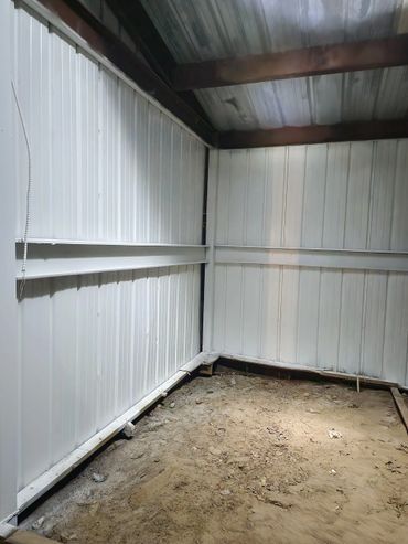 Barn cleanup in progress with debris removal and fresh coat of paint.