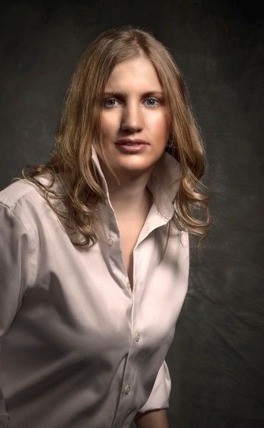 portrait of a young woman with blond hair in a studio