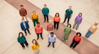 Diverse group standing in a geometric pattern.