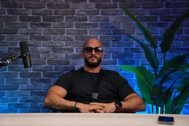 Podcaster in Dubai Podcast Studio in a brick wall setup