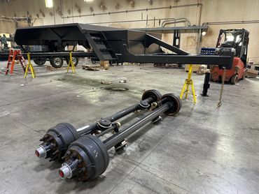 The trailer platform axle installation on the hose reel was made by Iron Shield Industries.