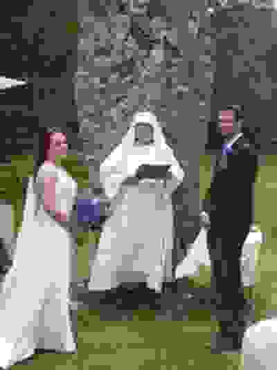 Bishop performs a handfasting wedding in front of a monolith in Ireland.
