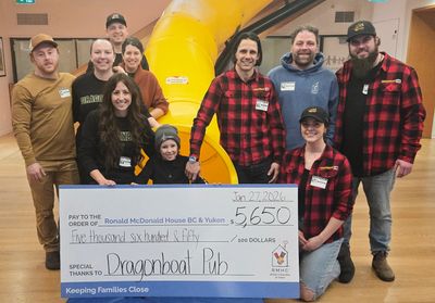 Dragonboat team members presenting a big donation to Ronald McDonald House BC and Yukon