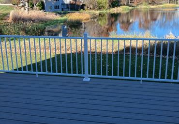 Composite deck with white aluminum railing by Thomm & Murf Remodeling, deck builders in Madison, WI.