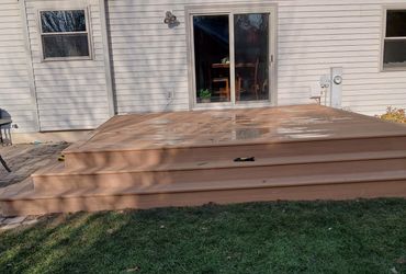 Composite decking with picture frame wrap-around stairs by Thomm & Murf deck builders in Madison, WI