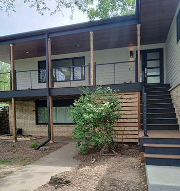 Composite decking with black fascia trim and cable railing by Thomm & Murf Remodeling, Madison, WI