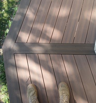 Two-tone picture framing composite decking by Thomm & Murf Remodeling, deck builders in Madison, WI