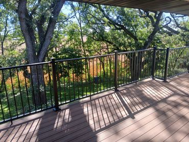 Two-tone picture frame composite deck with black railing by Thomm & Murf, deck builders in Madison