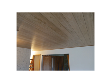 Cherry wood ceiling with nickel gap panels and custom trim in a finished basement.