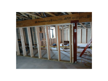 Framing a basement bedroom with new exterior window and insulated walls for added comfort.