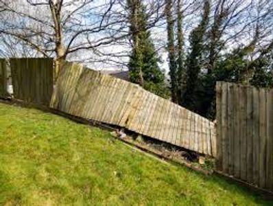 Damaged wooden fence that needs repairing