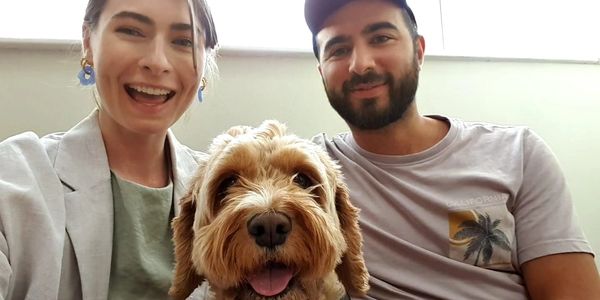 Happy couple with their cheerful dog.