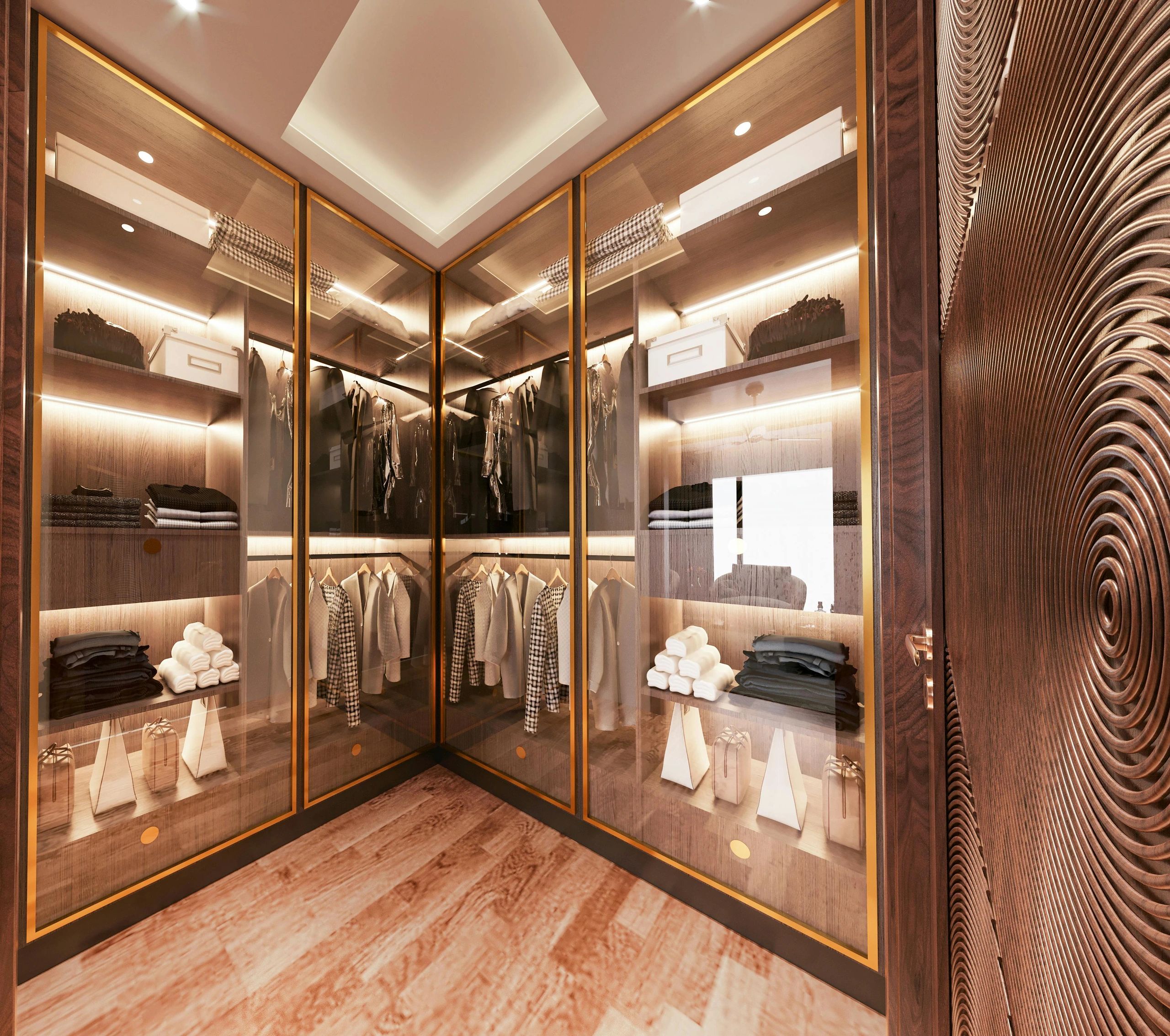 Modern walk-in closet with glass doors and warm lighting.