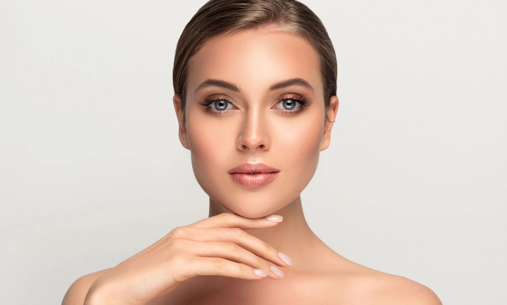 Woman showing her glowing face after treatment