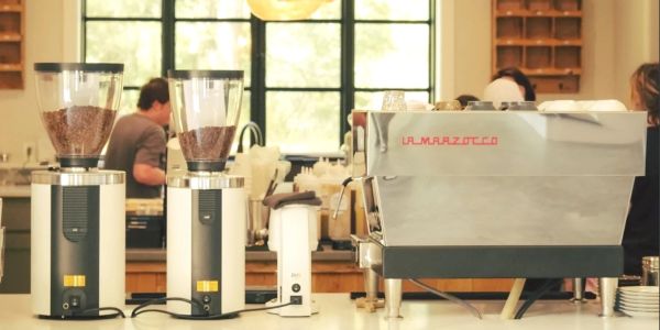 Espresso machine and coffee grinders on a cafe counter.