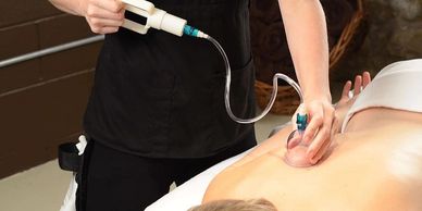 Therapist using cupping tools with a hand pump