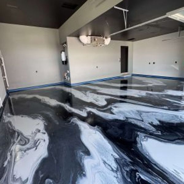 Black and white marbled epoxy floor in a room.
