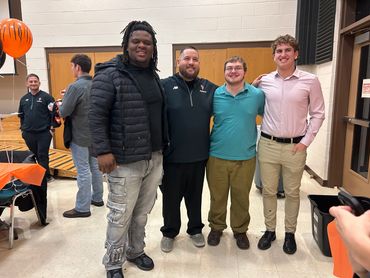 The boys at their senior football banquet
Left to right: Kam, Coach Hemby, Joe, and Nate