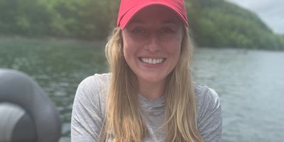 a person smiling representing the rewarding experience of fly fishing