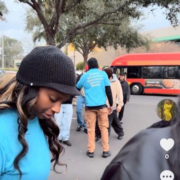 Group of people outdoors near a bus.
