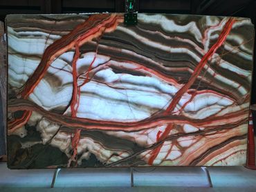 Premium Rainbow Onyx natural stone with colorful veining for luxury architectural projects.