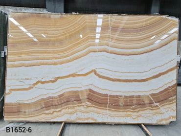 Premium Turkish Mango Onyx slab featuring elegant golden translucent natural stone patterns.