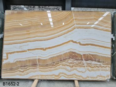 Exclusive Turkish Mango Onyx slab with warm golden veining and elegant appearance.