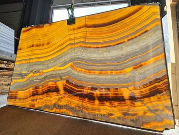 Natural Turkish Mango Onyx slab showcasing unique golden and cream layered veining.