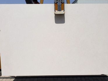 Limra Sesame Limestone slab with natural beige tones and sesame-like mineral markings.