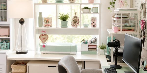 Donna's organized craft studio featuring a computer workstation, decoupage projects, craft supplies, storage shelves, and handmade décor in a bright, inspiring creative space.