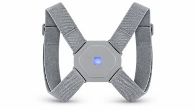 Gray posture corrector with a blue light in the center.