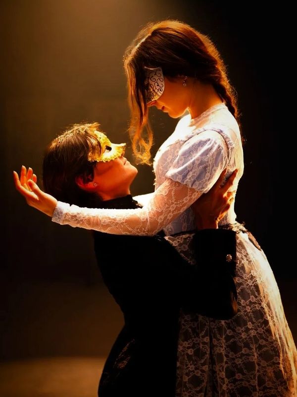 Two masked individuals in an intimate embrace, dressed in elegant attire in To Your Eternity the Ballet. Choreographed by Lara Paraschiv Composed by Daniel Ciobanu