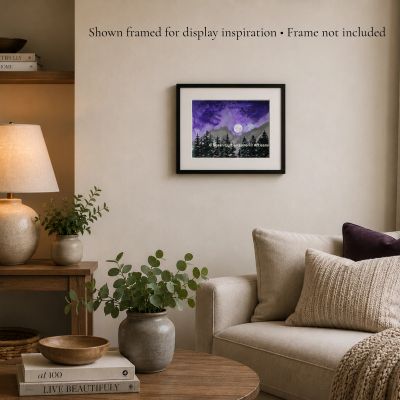 Moon Over the Firs watercolor painting displayed in a cozy living room with neutral decor.