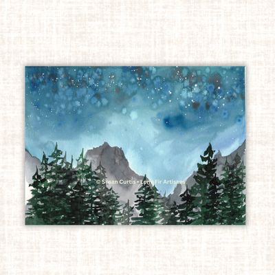 Mountain Starlight original watercolor painting featuring a star-filled blue night sky, distant mountains and evergreen trees.