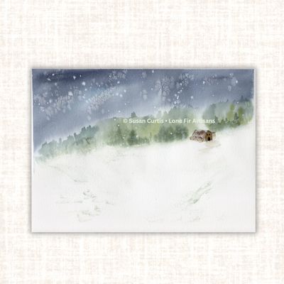 Original watercolor painting of a peaceful snowy landscape with a small cabin, evergreen trees, and falling snow.