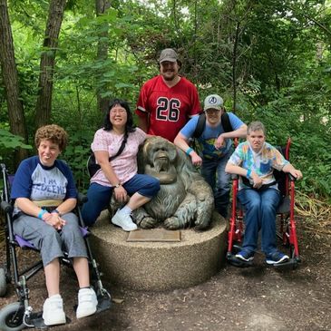 People posing for a picture with a chimpanzee