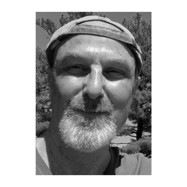 Black and white photo of author, William Winship. Bill is a white man in his 70s wearing a ball cap.