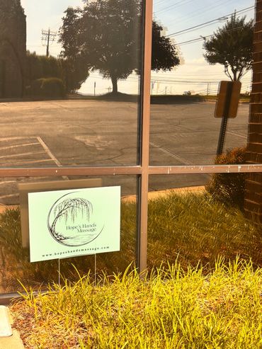 Blue “Hope’s Hands Massage Sign” out front of Suite 101, Building 935.