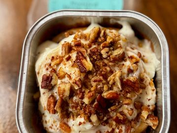 Cinnamon roll displayed in single serve tin.