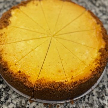 A sliced cheesecake with a graham cracker crust.