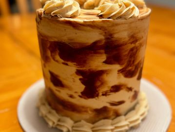 Chocolate cake with peanut butter frosting displayed on a table.