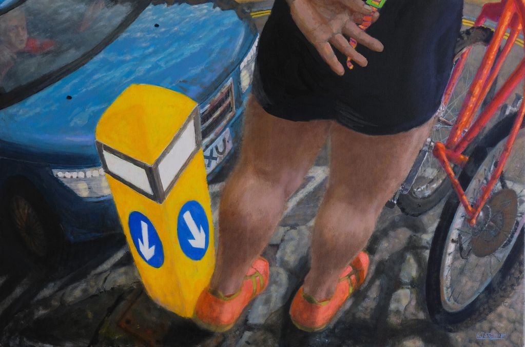 Cyclist with bike and car at a crossing