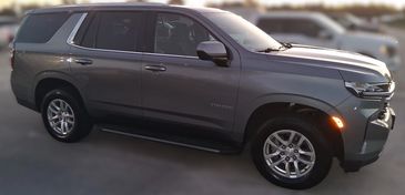 Gray Chevrolet Tahoe SUV parked outdoors at dusk.