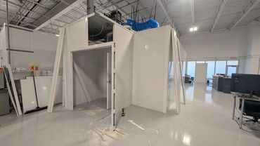 A fully customizable modular building being constructed inside a workspace office by SoFlo Installat
