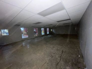 Inside a spacious, empty modular office building by SoFlo, featuring front windows and a completed d